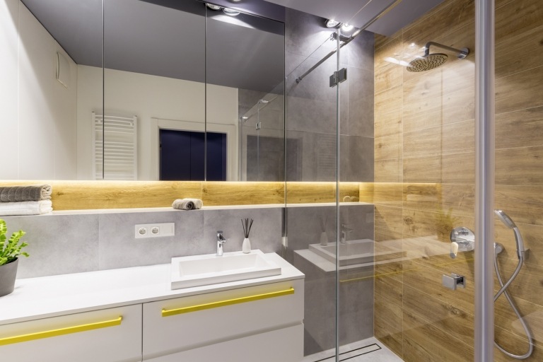 litet badrum design duschkabin indirekt belysning natursten kakel och stora badrum spegel