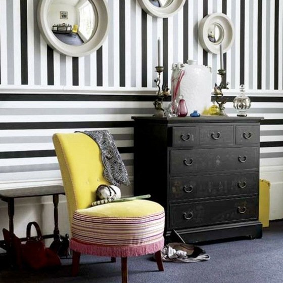 Retro-stil-med-gul-stoppad-stol-och-randig-tapet