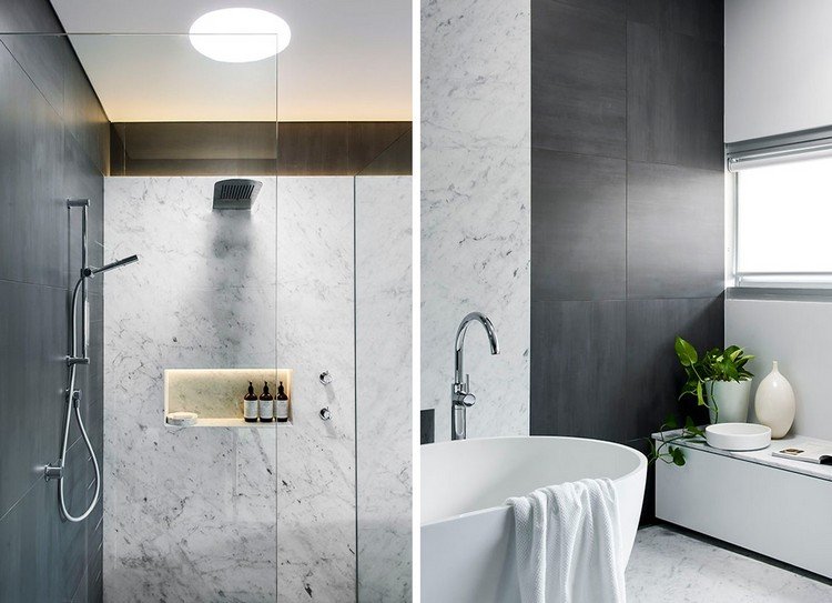 modernt badrum med dusch och badkar i marmor
