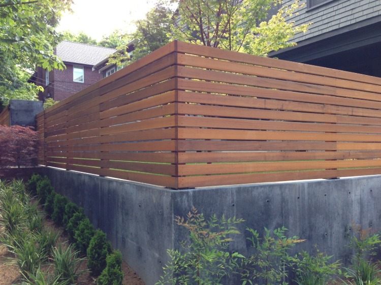 planterad trädgård med väggstaketkombination av trälister som infästning och betong i nedre delen