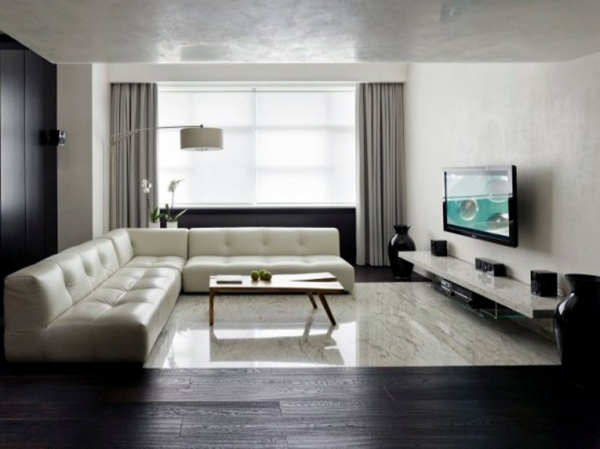 minimalistiskt vardagsrum quiltad hörnsoffa svart vit