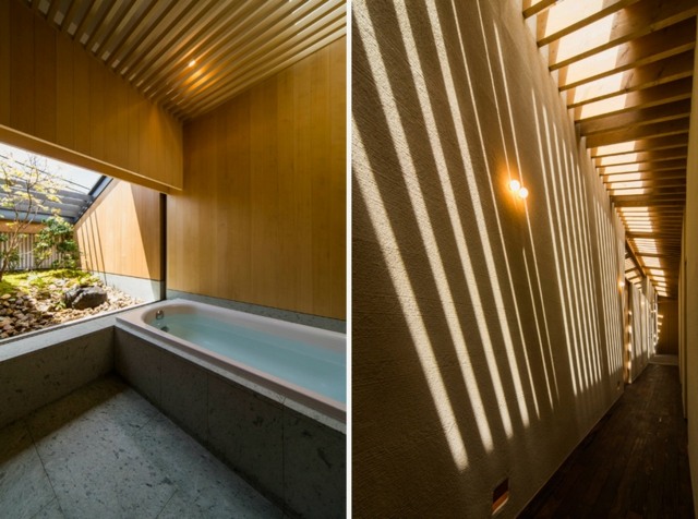 Badrum fristående badkar natursten kakel takfönster träbjälkar
