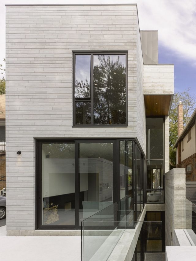 modernt smalt hus fasad grå kakel glasrutor svart ram