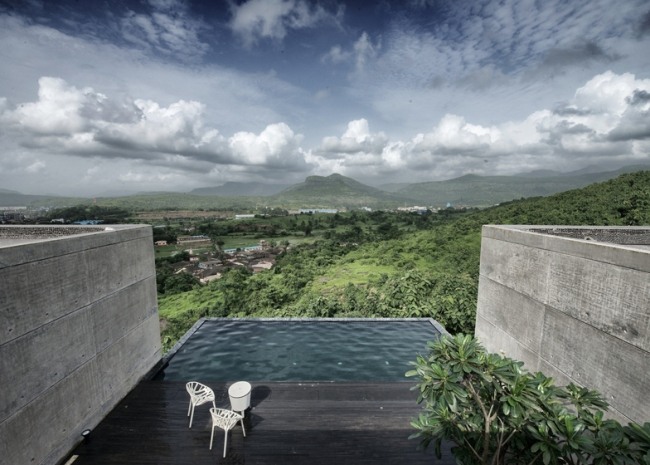 Designhus 2 byggnadsvolymer-betong basalt pool utsikt landskap