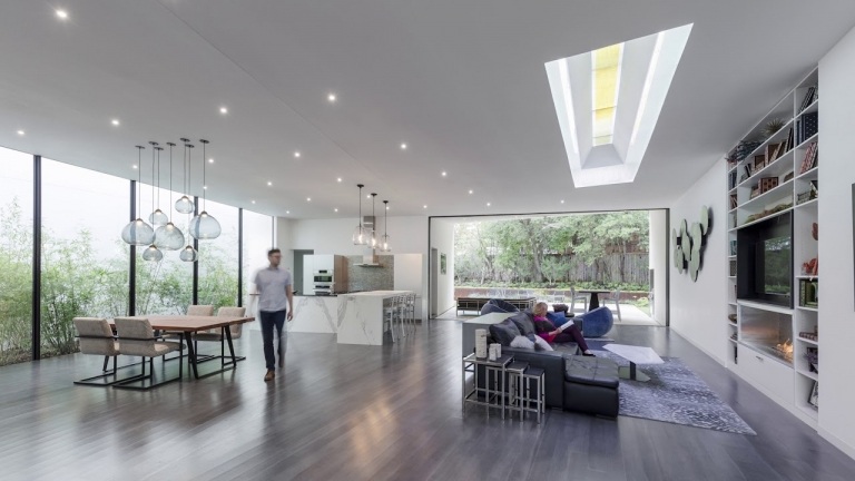 Hållbar byggnad av ett modernt enfamiljshus Takfönster i vardagsrummet släpper in mer solljus, rent energibesparande taklampor på kvällen