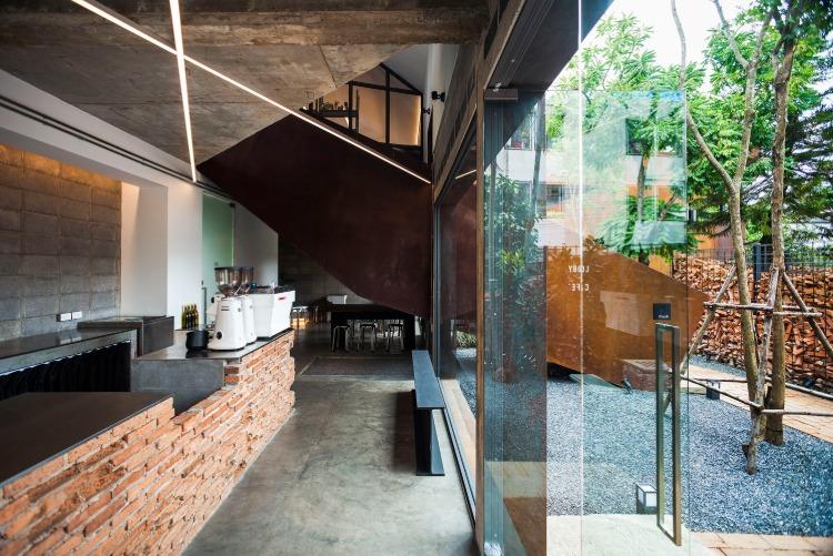 modernt designkafé med tegelvägg och betonggolvdörrgård med småsten