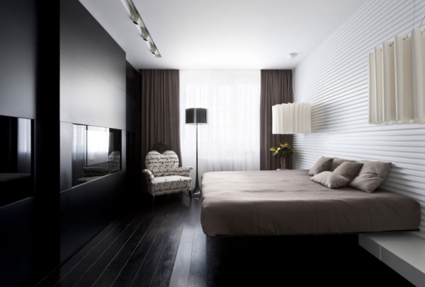 modern lägenhet sovrum svart matt öppen spis beige säng