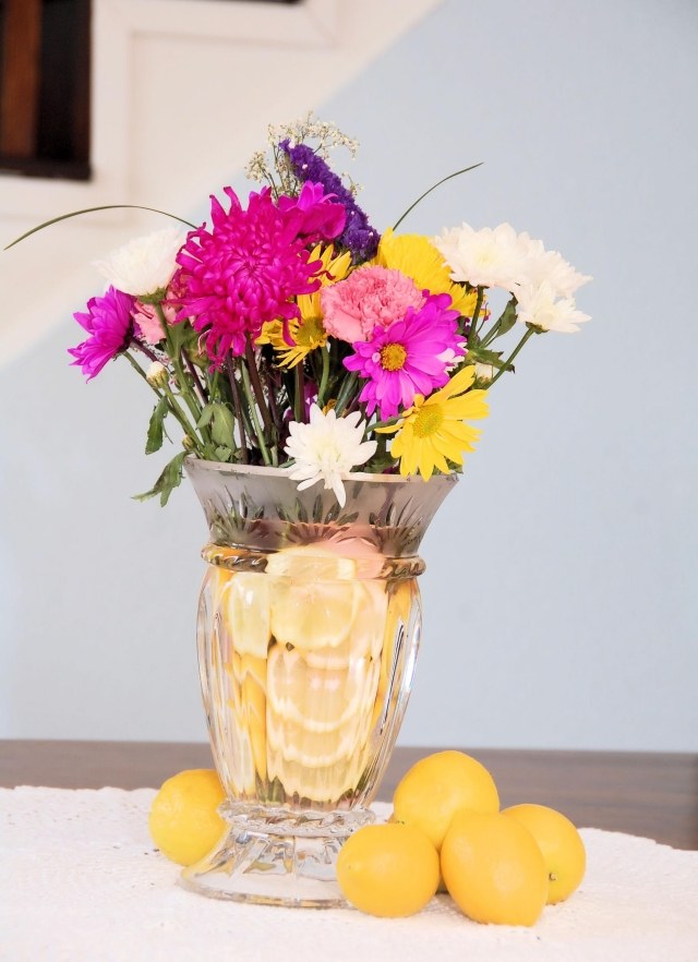Påskdekorationer gör blommor vaser citroner vatten