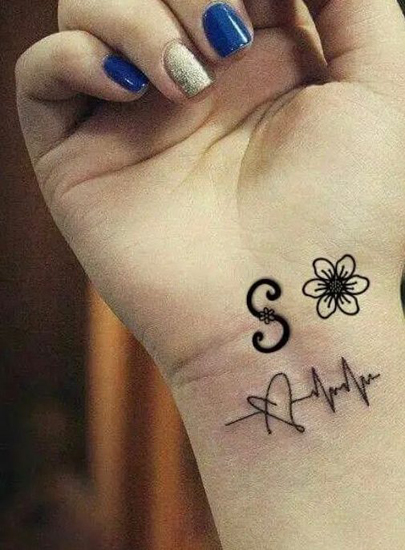 Kukkainen S -kirjain -tatuointi sydämenlyönnillä