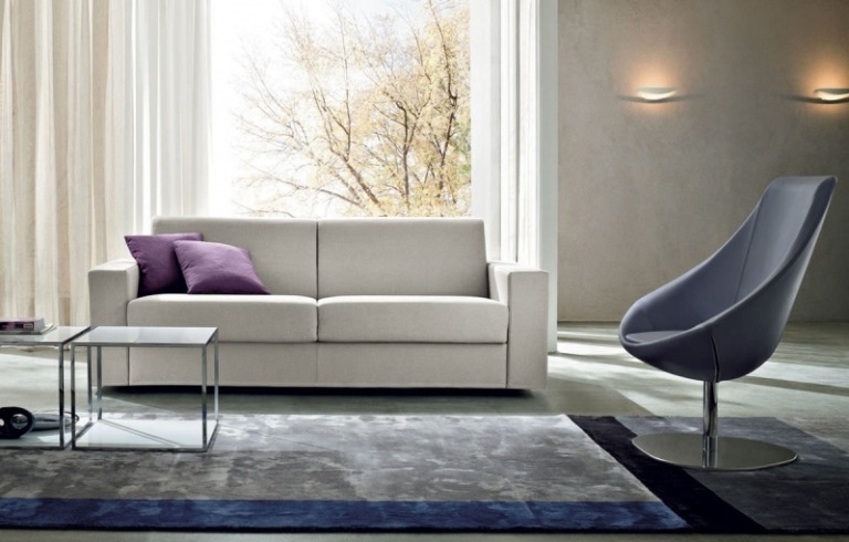 Bäddsoffa i grå-gardiner-vanlig fåtölj-matta-sidobord-belysning-fönstervägg