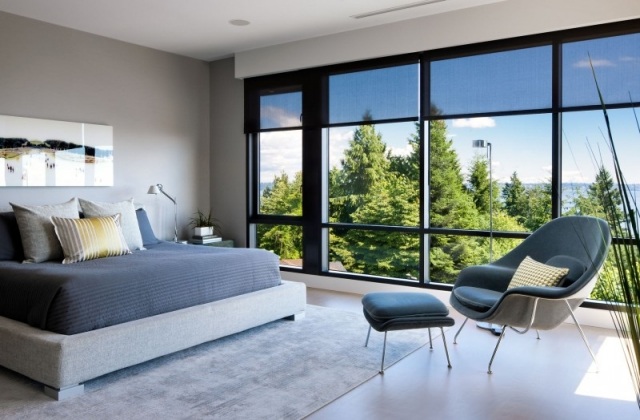modernt sovrumsfönster grå stoppad sängmatta koppla av fåtölj blå