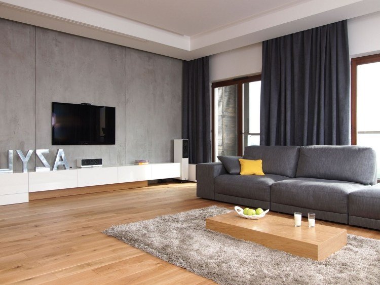 Trevligt-inredning-idéer-vardagsrum-tv-betongvägg-grå-trägolv-soffbord-block av trä