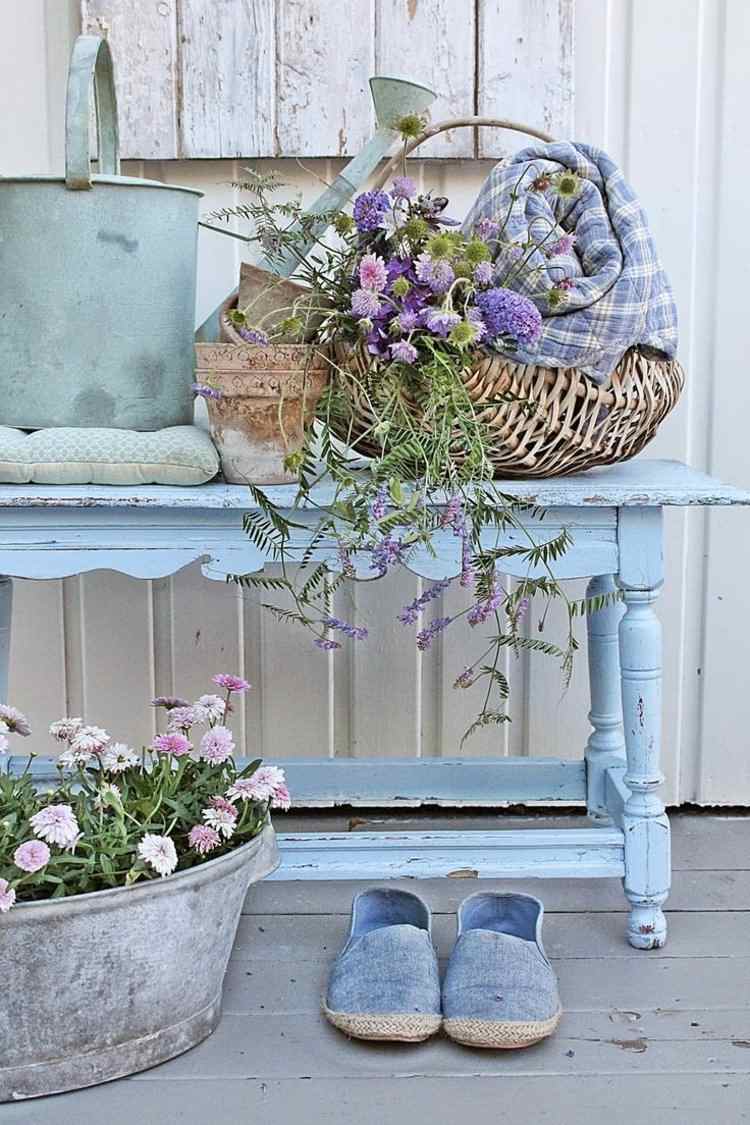 shabby-chic-trädgård-ljusblå-bänk-vattning-kan-rustik-korg-blommor