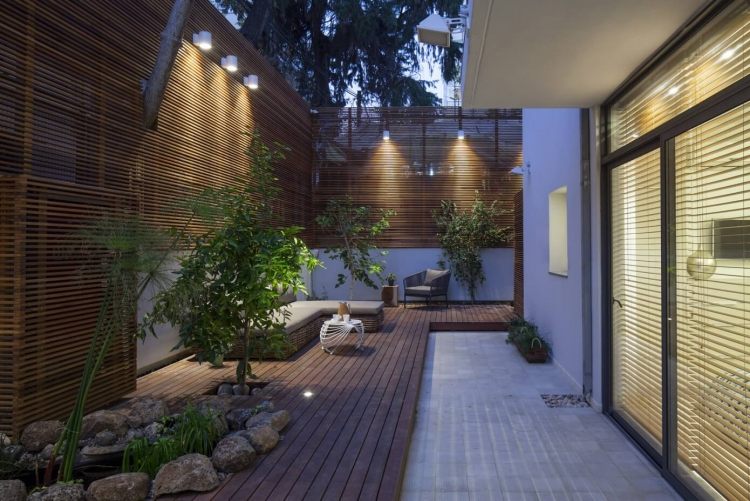 Sekretessskärm gjord av trä-trädgård-modern-belysning-växter-trä lameller-paneler-stad-lägenhet