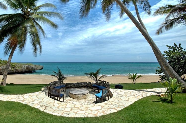 öppen spis-trädgård-sittplats-hav-exotiska-palmer-strand-bänk-rund-stoppad gräsmatta