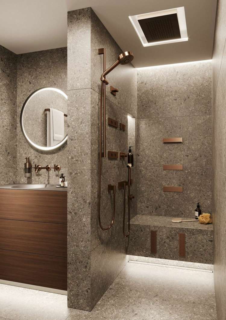 Öppen dusch med bänk och skiljevägg utgör en nisch för tvättstället med handfat