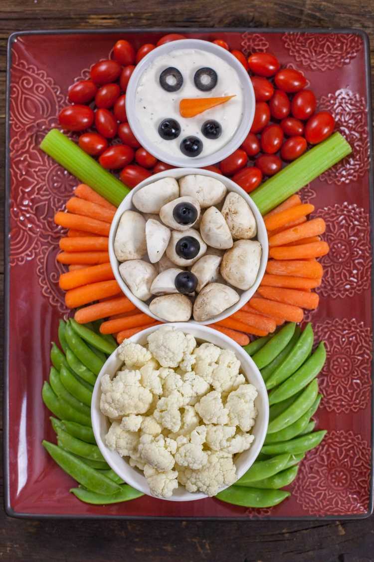 Rolig snögubbe gjord av grönsaker för en vinterfest