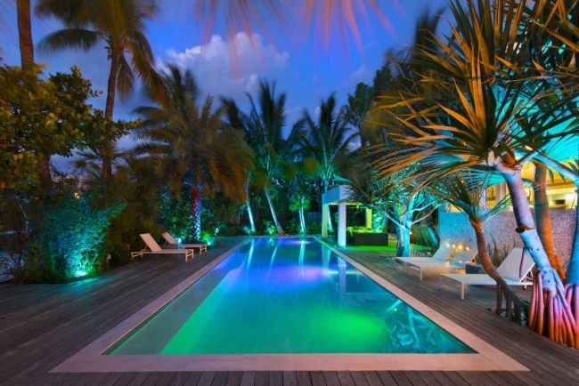 Villa Miami poolbelysning färger palmer trädäck Bankirai