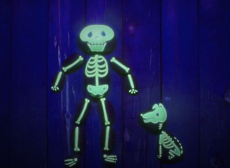 Måla stenar med fluorescerande färg för Halloween - skelett med hund