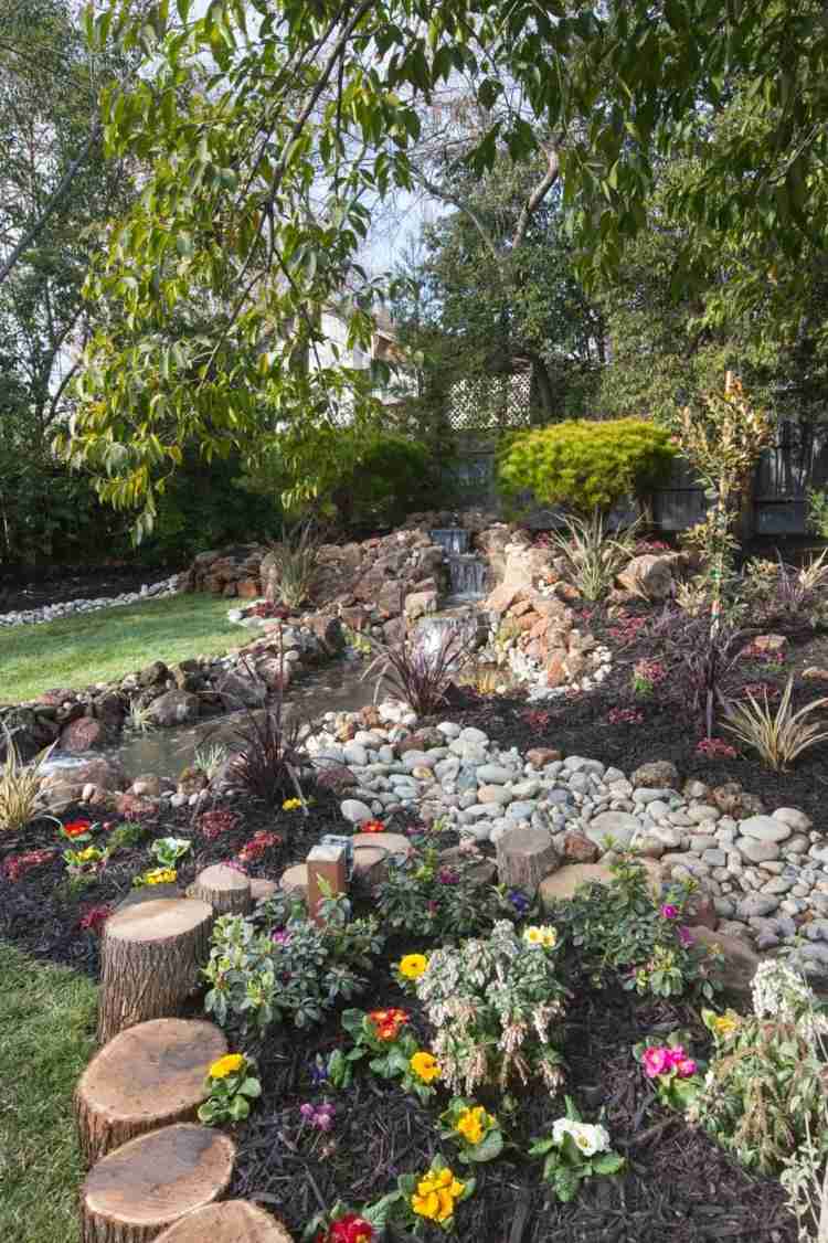 skapa sten trädgård stenar färgglada blommor träd stubbe design