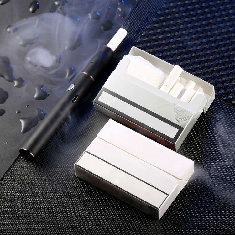 två lådor med tobakspinnar och munstycke för rökvärme, inte förbränning av tobaksvaror