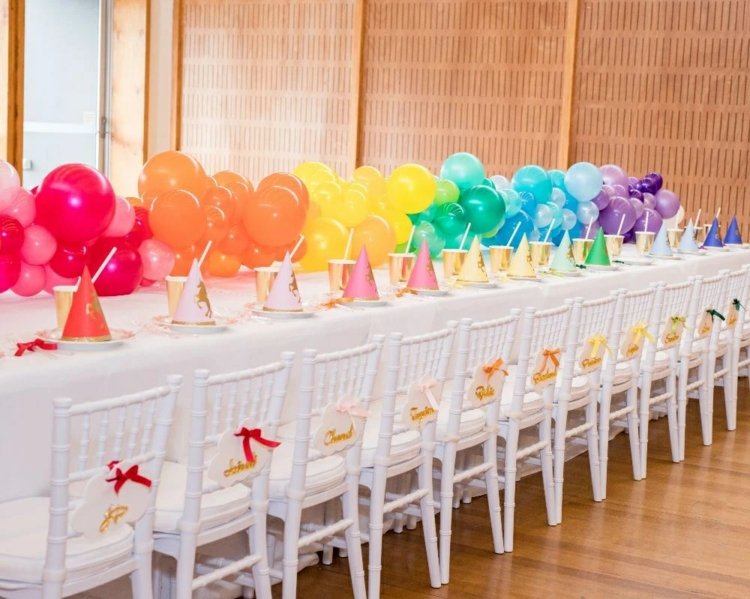 Regnbågsdekoration med ballonger till bordet på barnkalaset för Mardi Gras