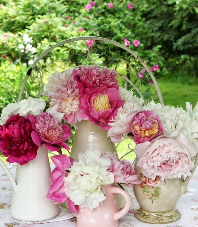 Vattenkanna vaser bord blomsterarrangemang vintage stil