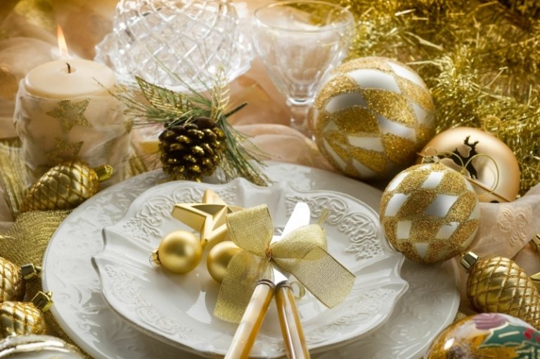 bordsdekorationer för jul guld accenter bollar tallkottar ljus