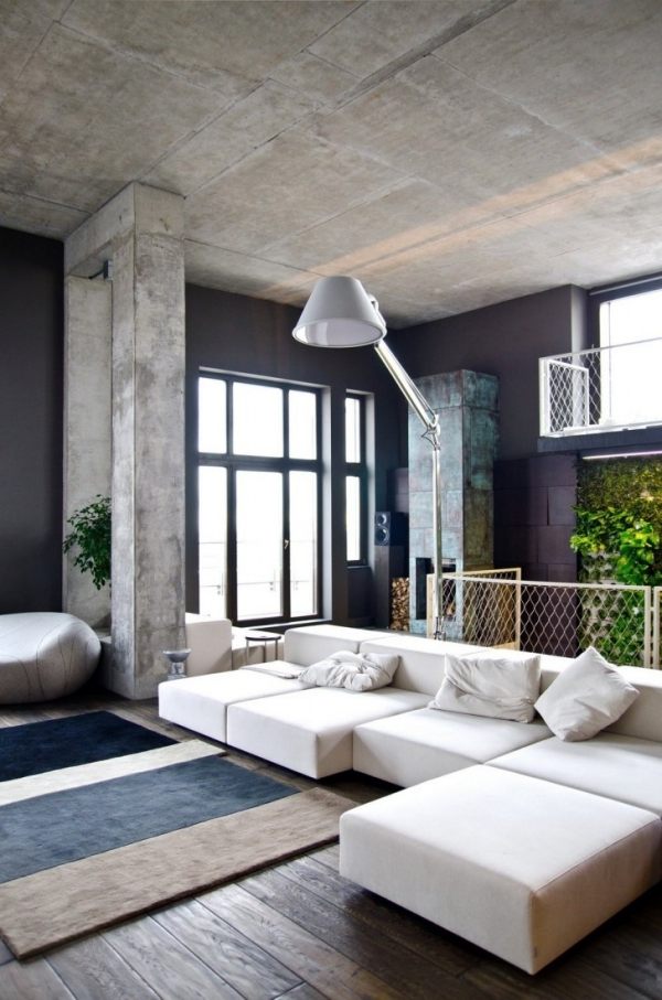 trendigt vardagsrum grå mörk lampa stoppad soffpall vit golvbeläggning design färgområde laminat