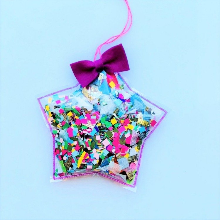 Gör presenter med pappersrester - 3D -stjärna med färgglada konfetti och rosett
