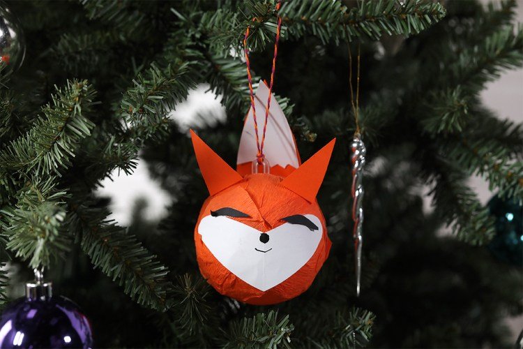 Roliga djur slår in julbollar i silkespapper med barnen som gör magiska skogsrävar