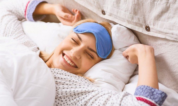 Kvinnan vaknar glad efter hälsosam sömn