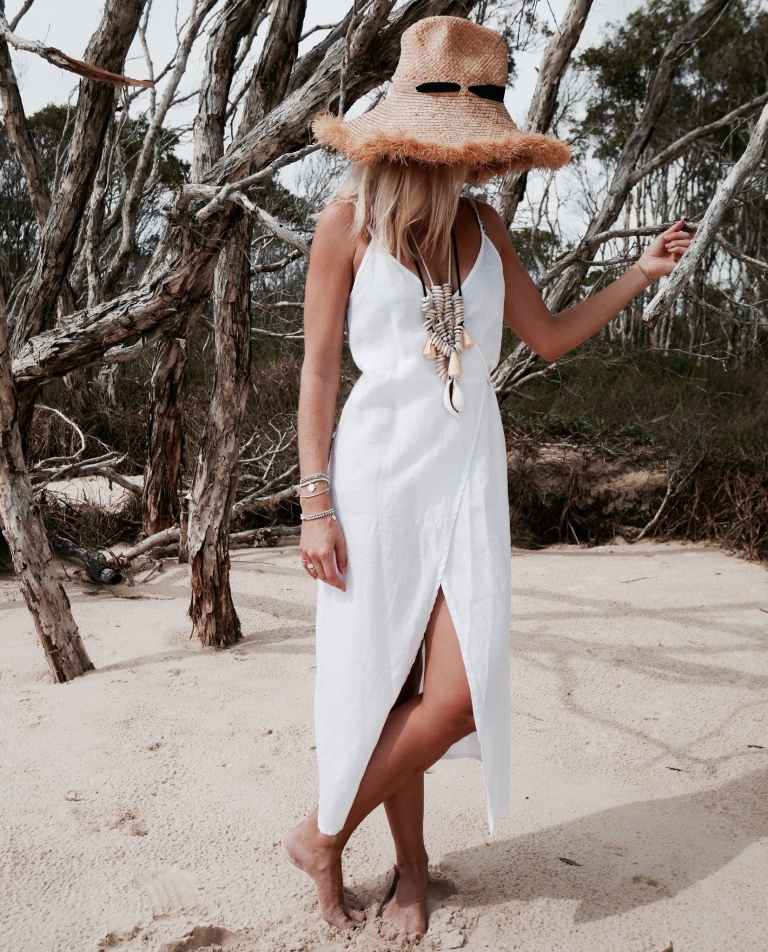 Linneomslagsklänning kombinerar sommar strandkläder halmhatt boho -look