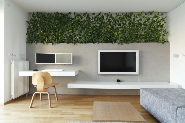väggdel-skrivbord-enkla-eleganta-tallrikar-vit-grå-soffa