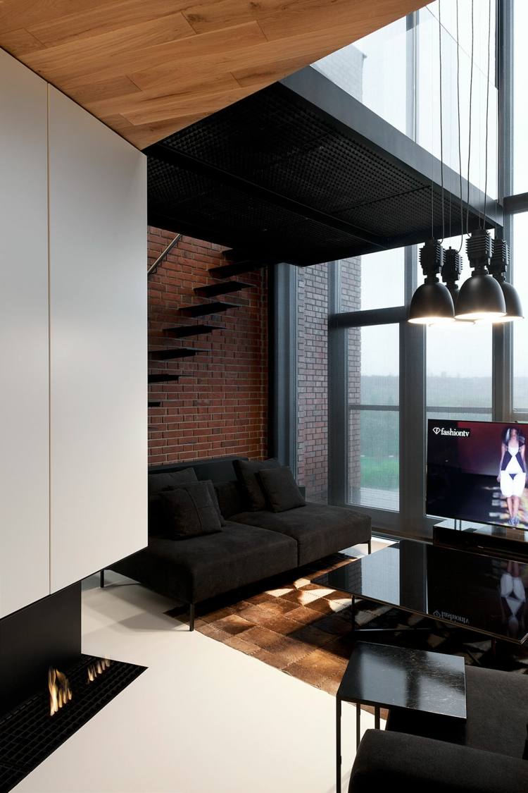 vardagsrum-idéer-svart-soffa-lyx-modern-tegel-vägg-öppen spis-högglans